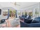 Bright living room features a ceiling fan, deck access, and comfortable blue seating at 6001-S32 S Kings Hwy., Myrtle Beach, SC 29575
