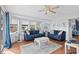 Bright living room with hardwood floors, neutral walls, ceiling fan, and comfortable seating for guests at 6001-S32 S Kings Hwy., Myrtle Beach, SC 29575