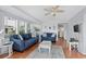 Bright living room with hardwood floors, neutral walls, ceiling fan, and comfortable seating for guests at 6001-S32 S Kings Hwy., Myrtle Beach, SC 29575