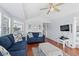 Bright living room featuring hardwood floors, neutral walls, ceiling fan, and comfortable seating at 6001-S32 S Kings Hwy., Myrtle Beach, SC 29575