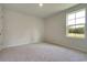 Simple bedroom with carpeted floor and a window at 899 Long Beach Dr, Longs, SC 29568