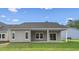 Rear view of the home featuring an outdoor patio space, lawn and windows at 9742 Indigo Creek Blvd., Murrells Inlet, SC 29576
