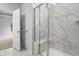 Modern bathroom featuring a marble tiled shower with glass door and a marble-floored entrance at 9742 Indigo Creek Blvd., Murrells Inlet, SC 29576