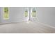 Sunlit bedroom features three windows, neutral carpeting, and ample space at 9742 Indigo Creek Blvd., Murrells Inlet, SC 29576
