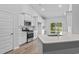 Bright kitchen features white cabinets, stainless steel appliances, and a spacious island with a sink at 9742 Indigo Creek Blvd., Murrells Inlet, SC 29576