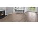 Open-concept living space with a fireplace, wood floors and a modern kitchen at 9742 Indigo Creek Blvd., Murrells Inlet, SC 29576