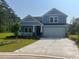 Charming single-Gathering home featuring a welcoming facade, manicured lawn, and a two-car garage at 9746 Indigo Creek Blvd., Murrells Inlet, SC 29576