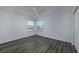 Well-lit bedroom with two windows, ceiling fan, and neutral walls at 2257 Essex Dr. # E, Surfside Beach, SC 29575