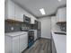Modern kitchen featuring white cabinets, stainless steel appliances, and a stylish backsplash at 2257 Essex Dr. # E, Surfside Beach, SC 29575