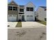 Charming, two-story townhouse with white siding, a blue door, and an attached single-car garage at 258-A Christiana Ln. # A, Myrtle Beach, SC 29579
