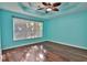 Bright bedroom with laminate floors, a fan, and window for natural light at 2783 Canvasback Trail, Myrtle Beach, SC 29588