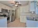 Kitchen features stainless steel appliances, white cabinets, and a neutral countertop at 2783 Canvasback Trail, Myrtle Beach, SC 29588