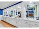 Long built-in white cabinets with mirrors and glass shelves at 374 N Cox Rd., Loris, SC 29569