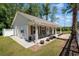 Clubhouse exterior with a charming front porch, lush landscaping, and classic architectural details at 603 Bucks Trail, Longs, SC 29568