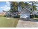 Charming single-story home featuring a well-manicured lawn and an attached two-car garage at 603 Bucks Trail, Longs, SC 29568