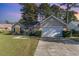 Charming single-story home featuring a well-manicured lawn and an attached two-car garage at 603 Bucks Trail, Longs, SC 29568