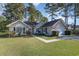 Well-maintained single-story home boasting a lush lawn and a convenient two-car garage at 603 Bucks Trail, Longs, SC 29568