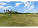 Picturesque golf course with clear blue skies, lush greenery, and golf carts on the fairway at 603 Bucks Trail, Longs, SC 29568