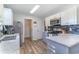 Bright kitchen with stainless steel appliances, granite countertops, and wood-look flooring at 603 Bucks Trail, Longs, SC 29568
