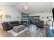 Open living room with vaulted ceilings, fireplace, sliding glass door to outdoor patio and hardwood floors at 603 Bucks Trail, Longs, SC 29568