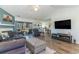 Bright living room with a fireplace, hardwood floors, patio access, and open layout at 603 Bucks Trail, Longs, SC 29568