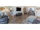 Spacious living room with hardwood floors adjacent to a dining area and kitchen at 603 Bucks Trail, Longs, SC 29568