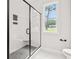 A modern bathroom featuring a black framed shower with grey tile and black fixtures at 805 Comanders Island Rd., Georgetown, SC 29440