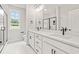 A bright bathroom with double sinks, a white vanity, and modern black fixtures at 805 Comanders Island Rd., Georgetown, SC 29440