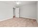 A carpeted bedroom features an open door and a ceiling fan at 805 Comanders Island Rd., Georgetown, SC 29440