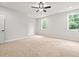A carpeted bedroom features a ceiling fan and two windows with natural light at 805 Comanders Island Rd., Georgetown, SC 29440