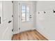 Mudroom entry featuring wood-look flooring, wainscotting, and a glass-paneled door at 805 Comanders Island Rd., Georgetown, SC 29440