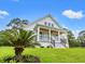 Inviting two-story home with a charming front porch and well-manicured lawn at 805 Comanders Island Rd., Georgetown, SC 29440