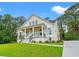 Beautiful exterior elevation with inviting porch, detailed trim, and manicured landscaping at 805 Comanders Island Rd., Georgetown, SC 29440