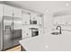 Modern kitchen featuring white cabinets, stainless steel appliances, and an island with a sink at 805 Comanders Island Rd., Georgetown, SC 29440