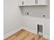 Laundry area with laminate flooring and utility sink hookups at 805 Comanders Island Rd., Georgetown, SC 29440