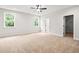 Spacious main bedroom featuring two windows, plush carpet and a walk-in closet at 805 Comanders Island Rd., Georgetown, SC 29440