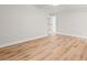 An open room with light hardwood floors and white baseboards offers space at 805 Comanders Island Rd., Georgetown, SC 29440