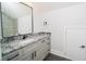 Bathroom featuring a granite vanity with black fixtures and view into the tiled shower at 1010 Club House Dr., North Myrtle Beach, SC 29582