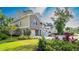 Exterior view features a brick and shake sided home with a two car garage and mature landscaping in a green yard at 1010 Club House Dr., North Myrtle Beach, SC 29582