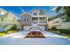 Beautiful two-story home with a brick facade, double garage, and charming front porch at 1010 Club House Dr., North Myrtle Beach, SC 29582