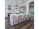 Stylish kitchen with white cabinetry, island seating, and views into the adjacent living room at 1010 Club House Dr., North Myrtle Beach, SC 29582