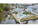 Aerial view of a bright community pool surrounded by palm trees with beautiful waterways in the background at 1010 Club House Dr., North Myrtle Beach, SC 29582