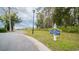 Neighborhood entry sign for boat and RV storage with a grassy field and tree line in the background on a cloudy day at 1010 Club House Dr., North Myrtle Beach, SC 29582