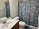 Bathroom featuring a single sink, a large mirror, and a tropical themed shower curtain at 1060 Fairway Ln. # 1060, Conway, SC 29526