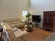 Comfortable living room with cozy couches, glass table, and television at 1060 Fairway Ln. # 1060, Conway, SC 29526