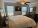 This main bedroom features a ceiling fan, two large windows, and a matching dresser with mirror at 1060 Fairway Ln. # 1060, Conway, SC 29526