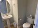 Powder room featuring a pedestal sink, a large oval mirror, and tiled floors at 1060 Fairway Ln. # 1060, Conway, SC 29526