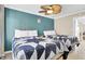 Comfortable bedroom with two beds, ceiling fan, and calming teal accent wall at 2001 S Ocean Blvd. # 1506, Myrtle Beach, SC 29577