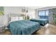 Bedroom with two beds, ocean view, and simple decorations that provides a relaxing space at 2001 S Ocean Blvd. # 905, Myrtle Beach, SC 29577