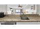 Kitchen counter with granite countertops overlooks living room and ocean view at 2001 S Ocean Blvd. # 905, Myrtle Beach, SC 29577